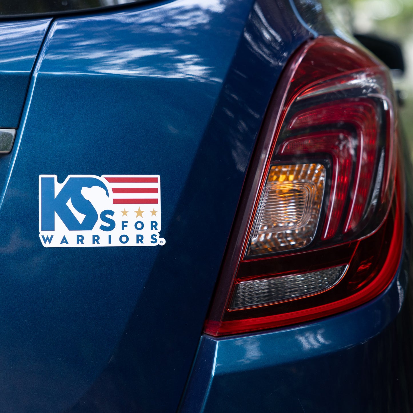 Blue car with 'K9s for Warriors' logo on the trunk