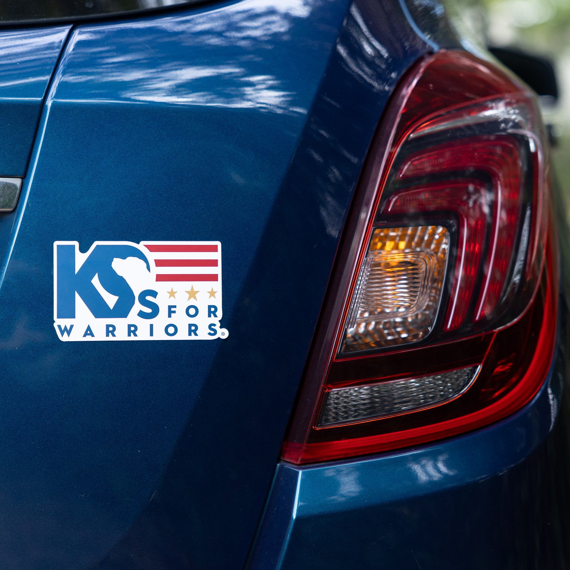 Blue car with 'K9s for Warriors' logo on the trunk